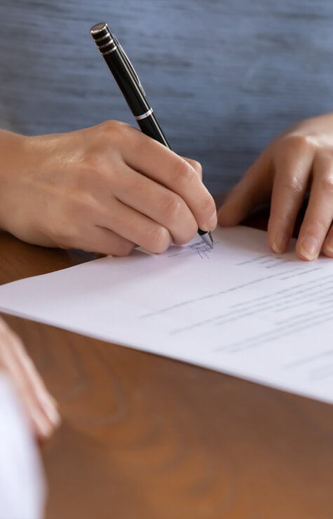 woman signing documents