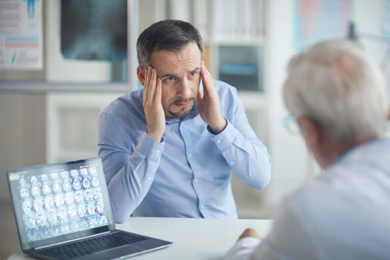 Man explaining his headache to doctor