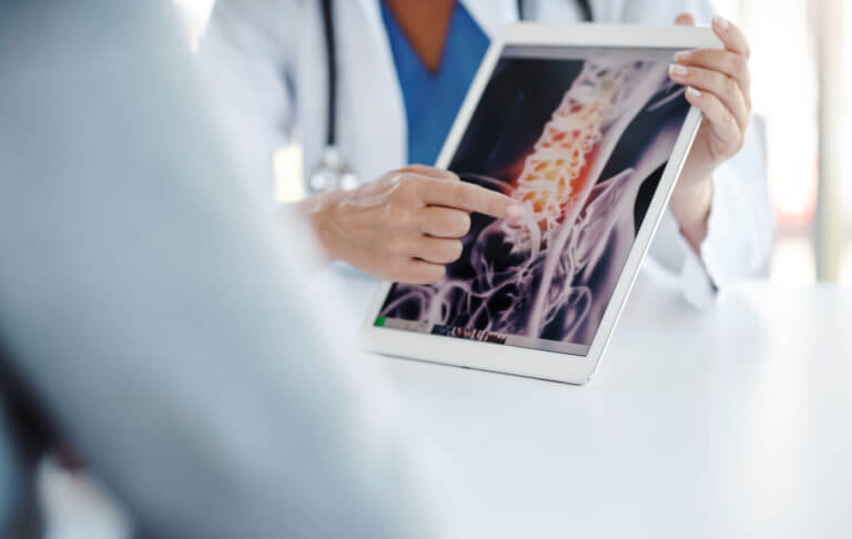 Doctors evaluating a patient's spinal scan