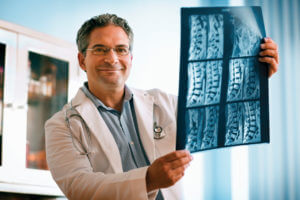 Doctor reading an MRI of a spine