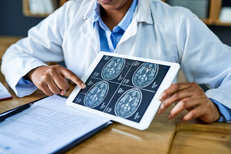 Neurosurgeon Analysing brain scan