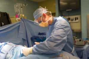 Spine Surgeon operating on a patient in an operating room