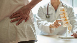 A doctor explaining risks of spine surgery