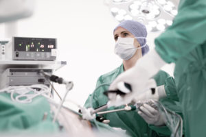 Woman surgeon performing minimally invasive spinal surgery