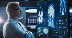 Neurosurgeon Looks at TV Screen with Brain MRI Scan Images